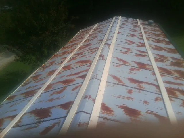Rusted metal roof panels with new wood purlins before replacement — Storm Damage Roof Repair in Stanfordville by Roofing Brothers