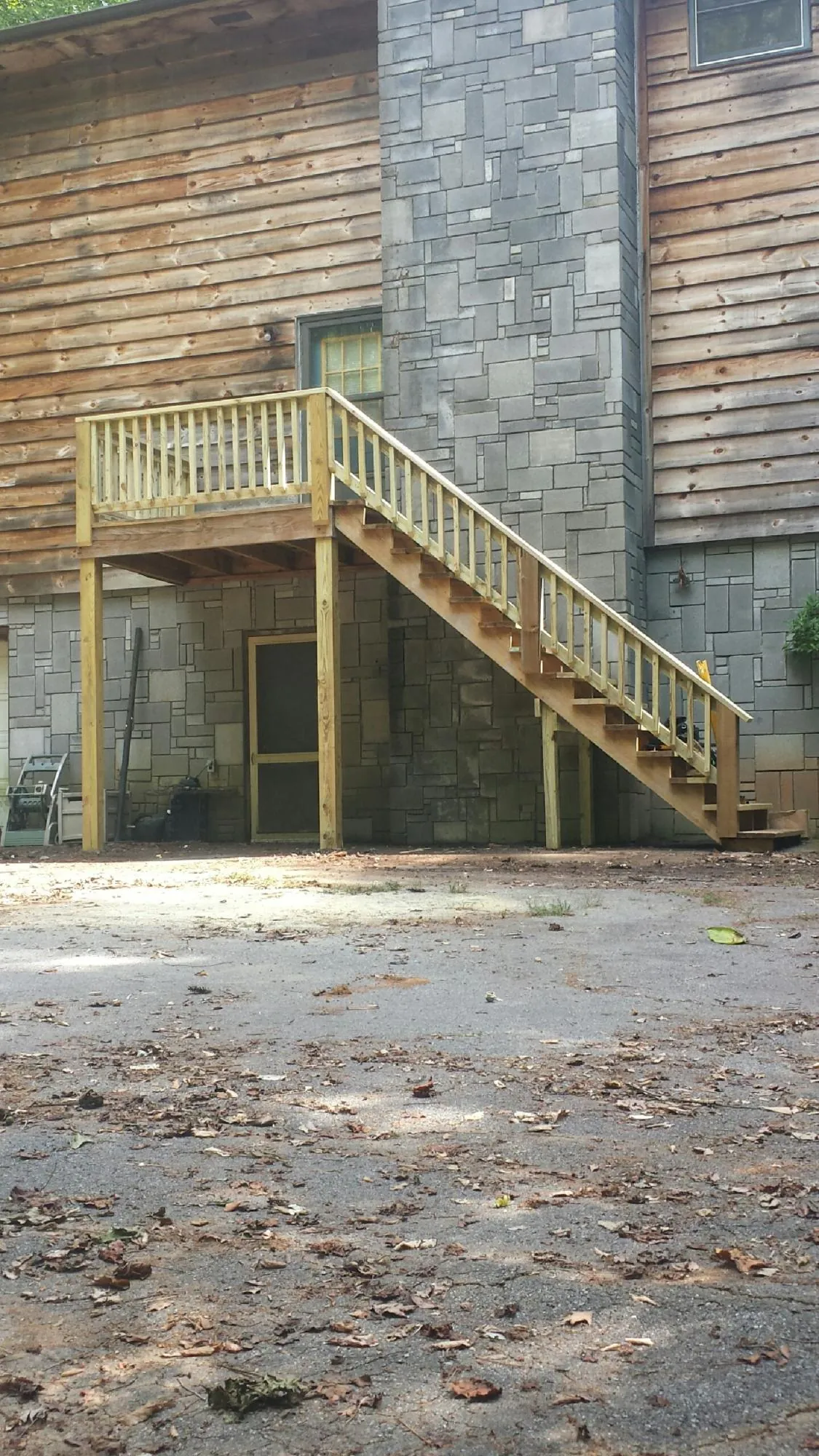 New pressure treated deck and stair landing on a log home in Stanfordville