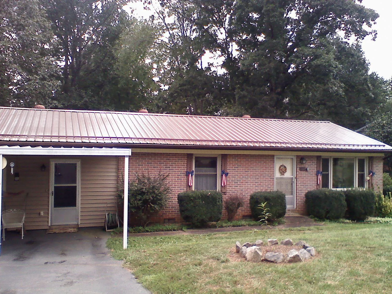 Bronze metal roof and carport on a brick ranch home — Roof Repair work by our crew in Stanfordville